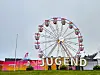 Fargerikt tivoli med stort pariserhjul og «LEGEND»-skilt.